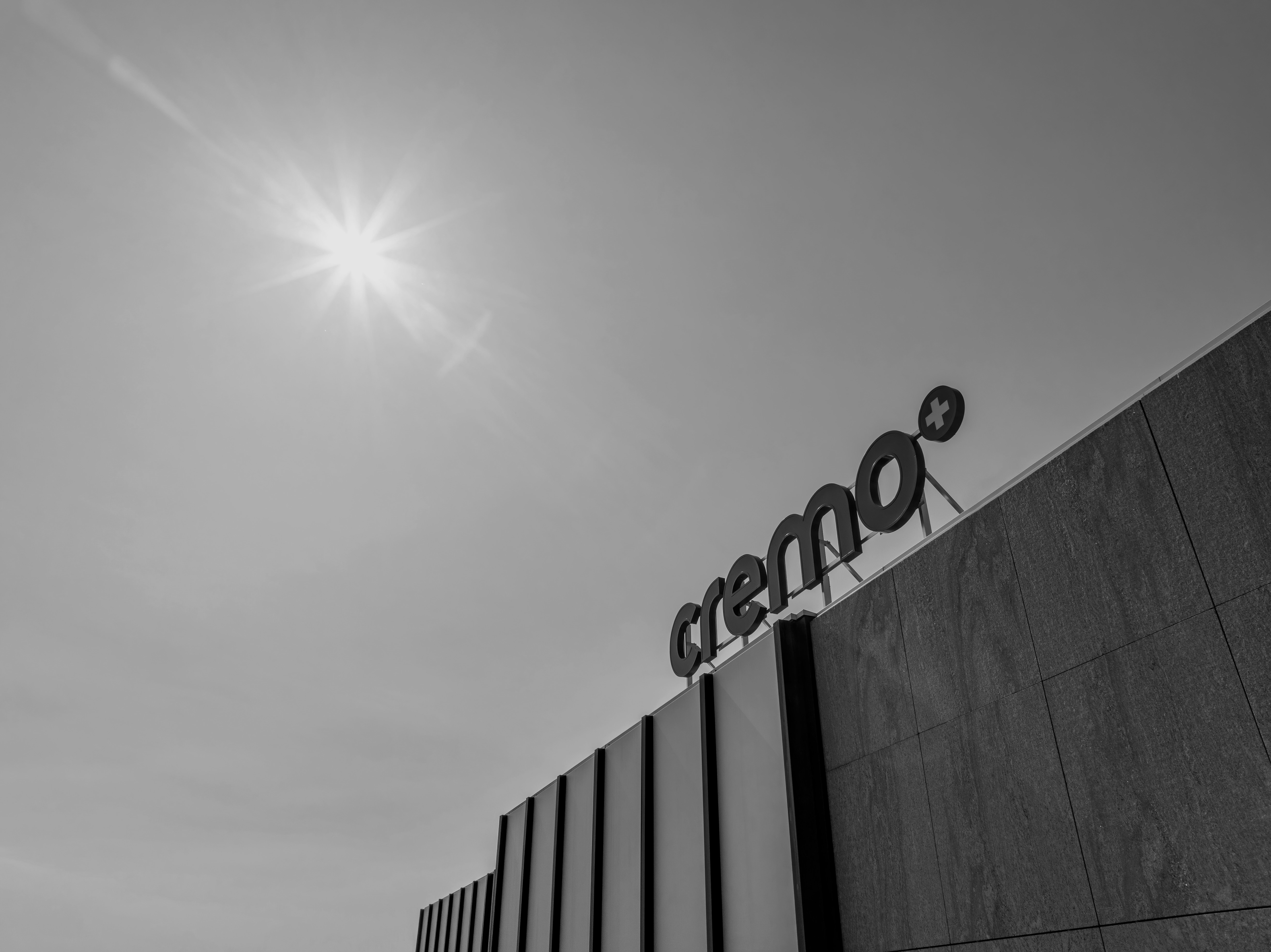 The Cremo logo on their head quarter in a black and white photography